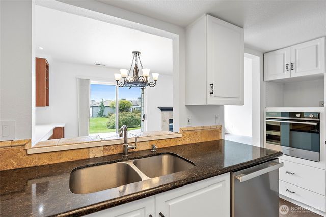 a kitchen with a sink and cabinets