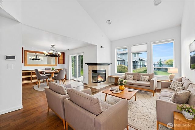 a living room with furniture fireplace and a large window