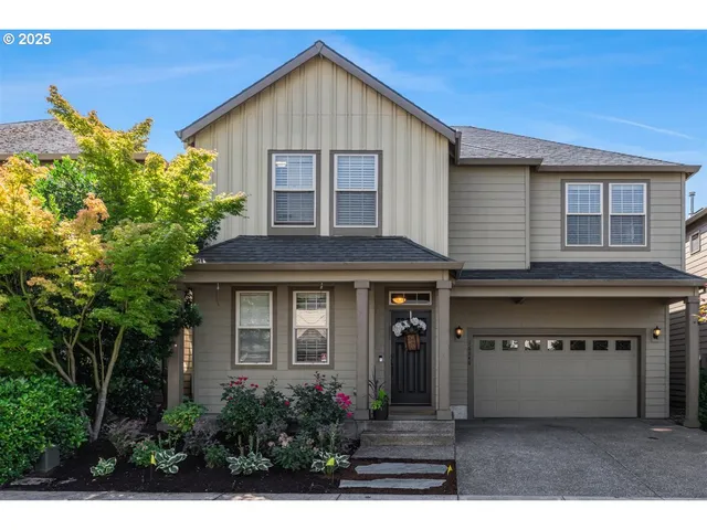 a front view of a house with a garden