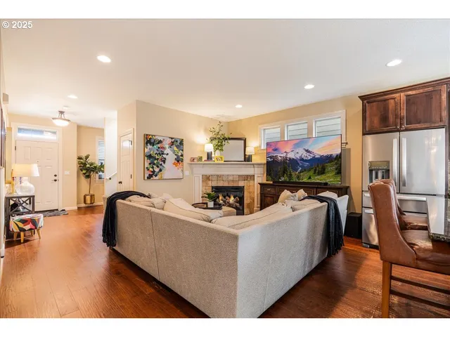 a living room with furniture and kitchen view