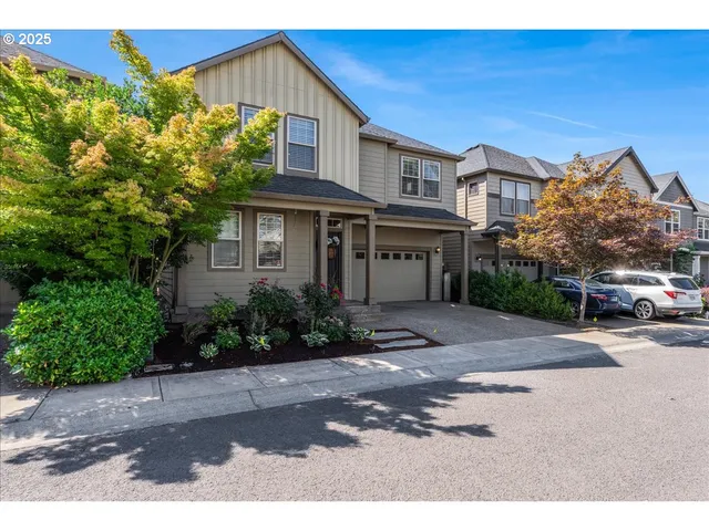 a view of a house with a yard and potted plants