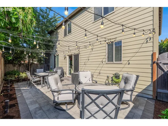 a backyard of a house with table and chairs