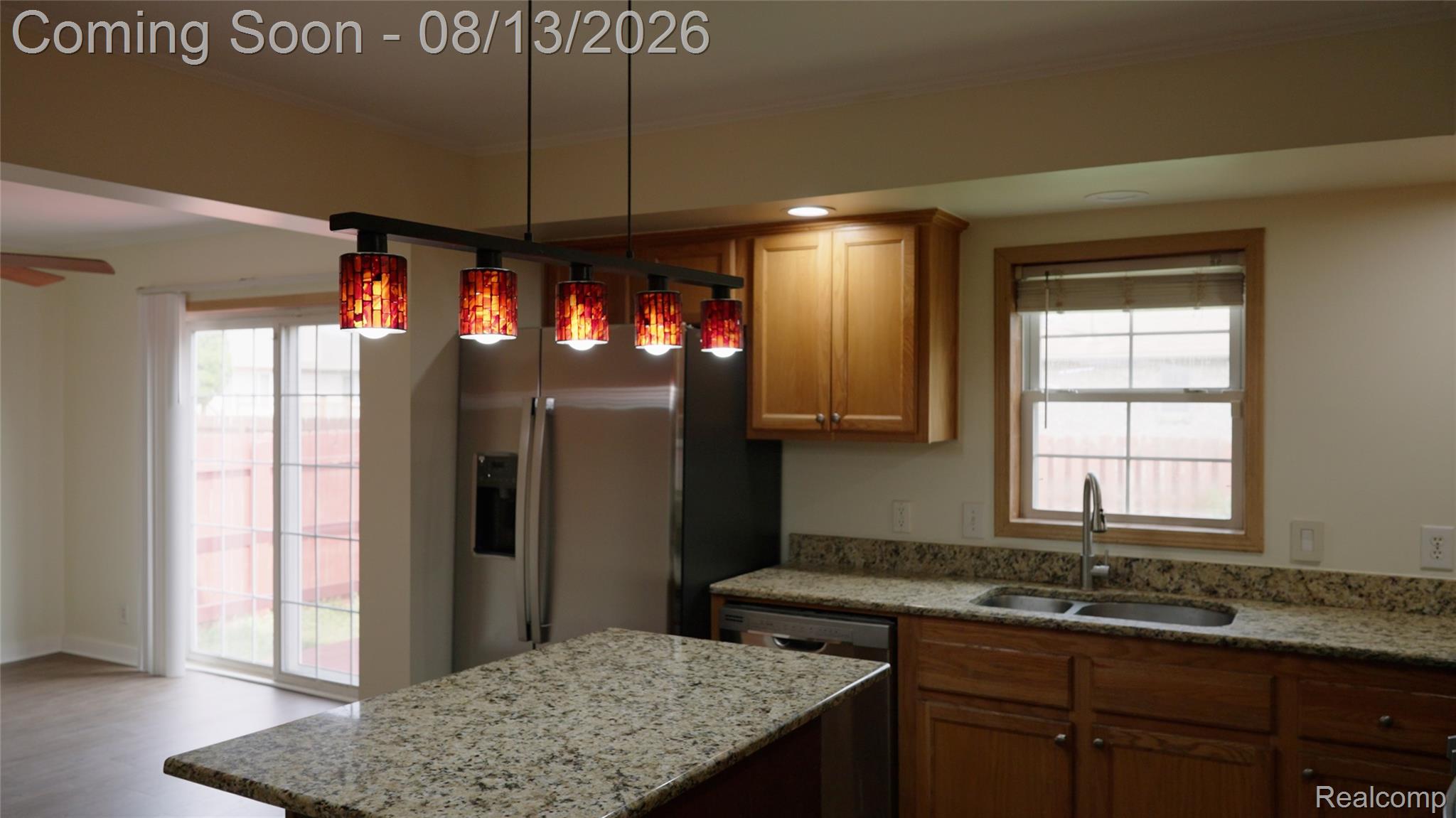 2018 John R Road Troy, MI 48083 - Photo 55 of 57 Kitchen island with granite-finish countertop, wood-finish cabinetry, and stainless steel appliances