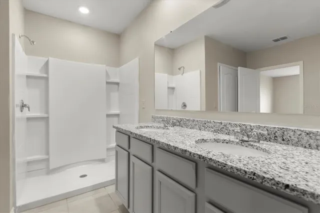 a bathroom with a granite countertop sink mirror and double