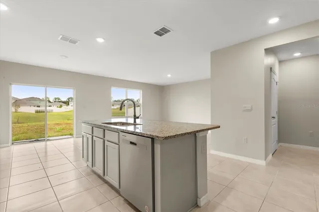 a kitchen with granite countertop a sink and cabinets