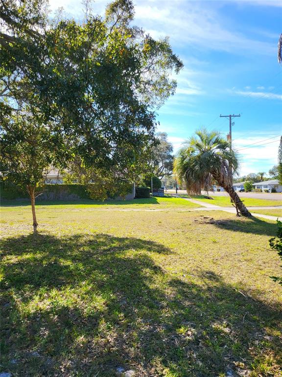 2131 Northeast Coachman Road Clearwater, FL 33765 - Photo 3 of 11 a view of a swimming pool with an outdoor space and seating area