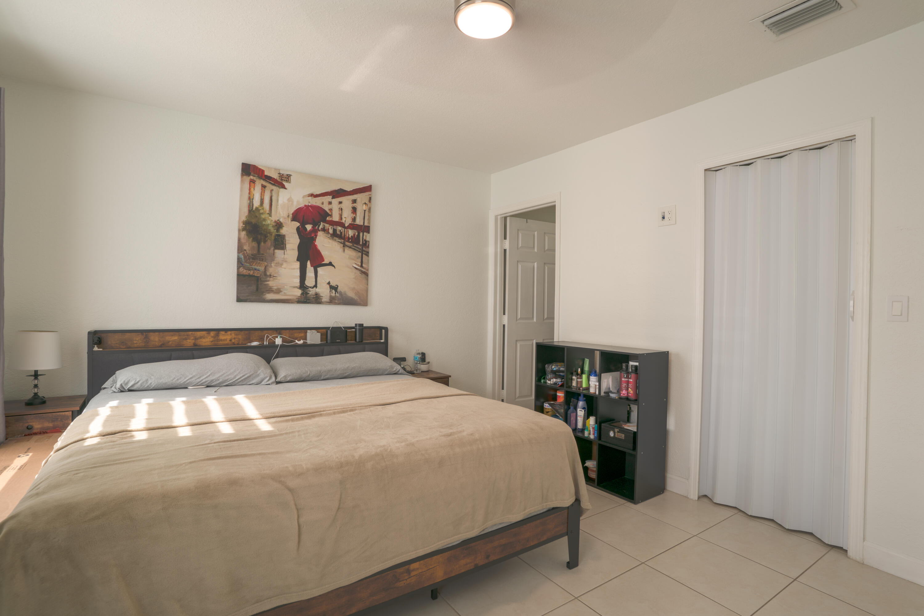13257 Southwest 277th Terrace Homestead, FL 33032 - Photo 15 of 24 a bedroom with a bed and a table