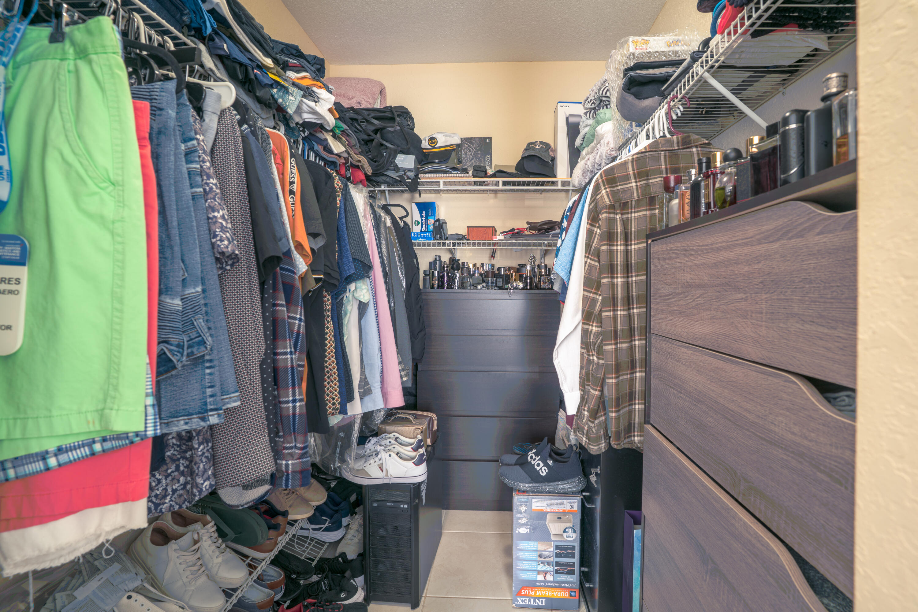 13257 Southwest 277th Terrace Homestead, FL 33032 - Photo 17 of 24 a view of walk in closet with clothes and shoes