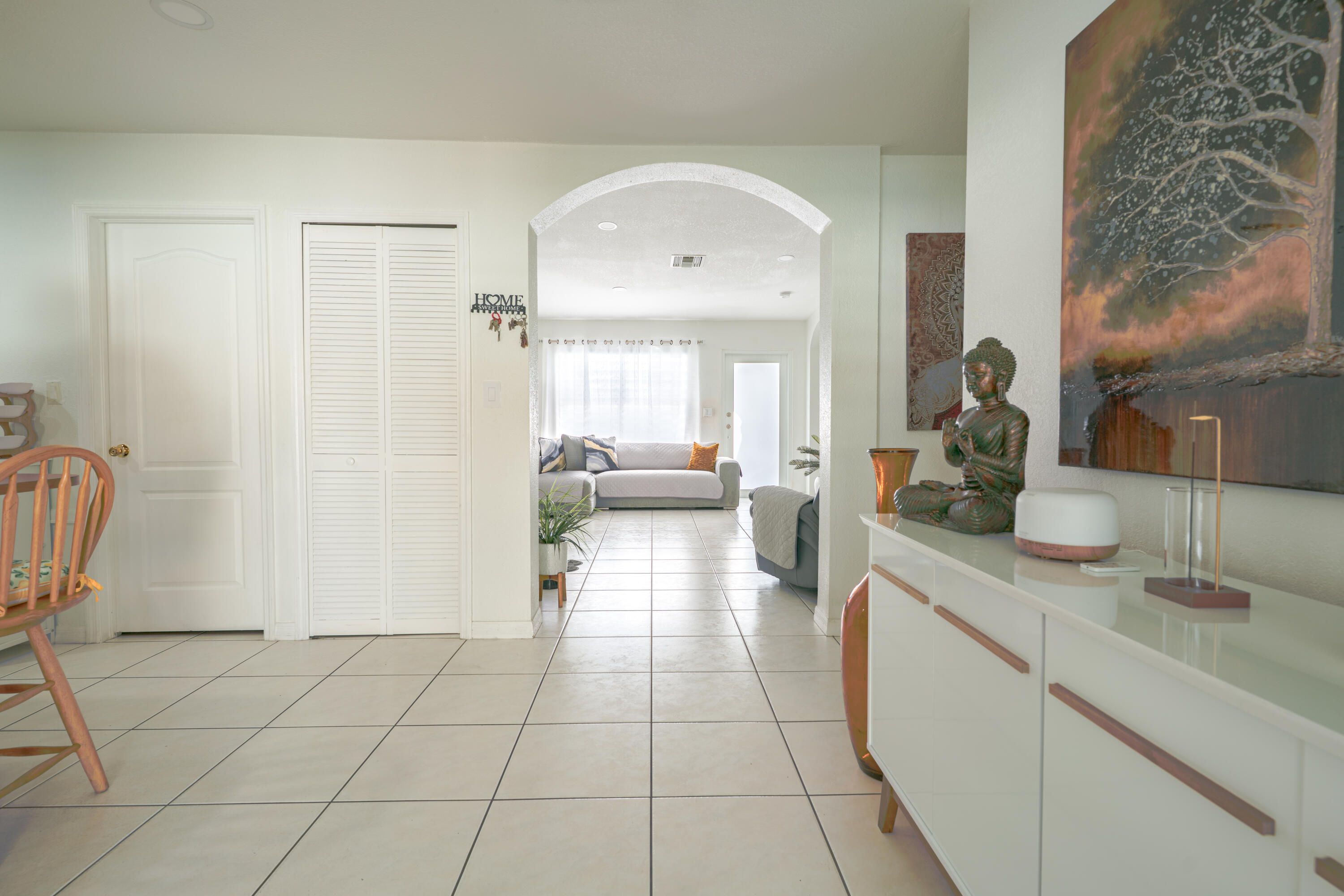13257 Southwest 277th Terrace Homestead, FL 33032 - Photo 7 of 24 a hallway with a dining table chairs and mirrors