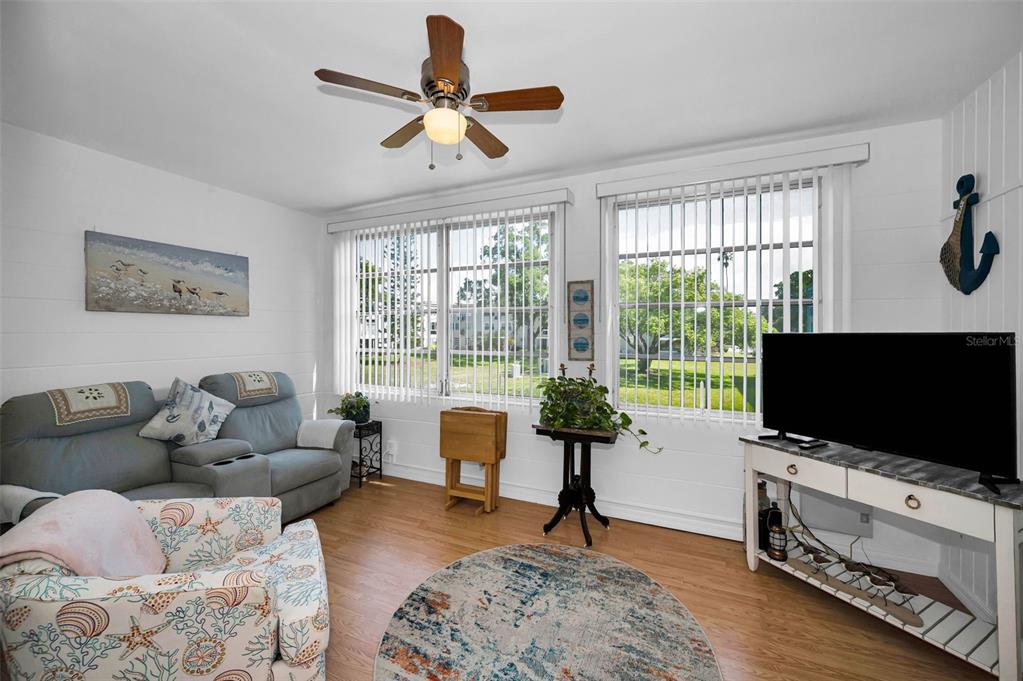 2043 Denmark Street, Unit 39 Clearwater, FL 33763 - Photo 11 of 37 a living room with furniture and a flat screen tv