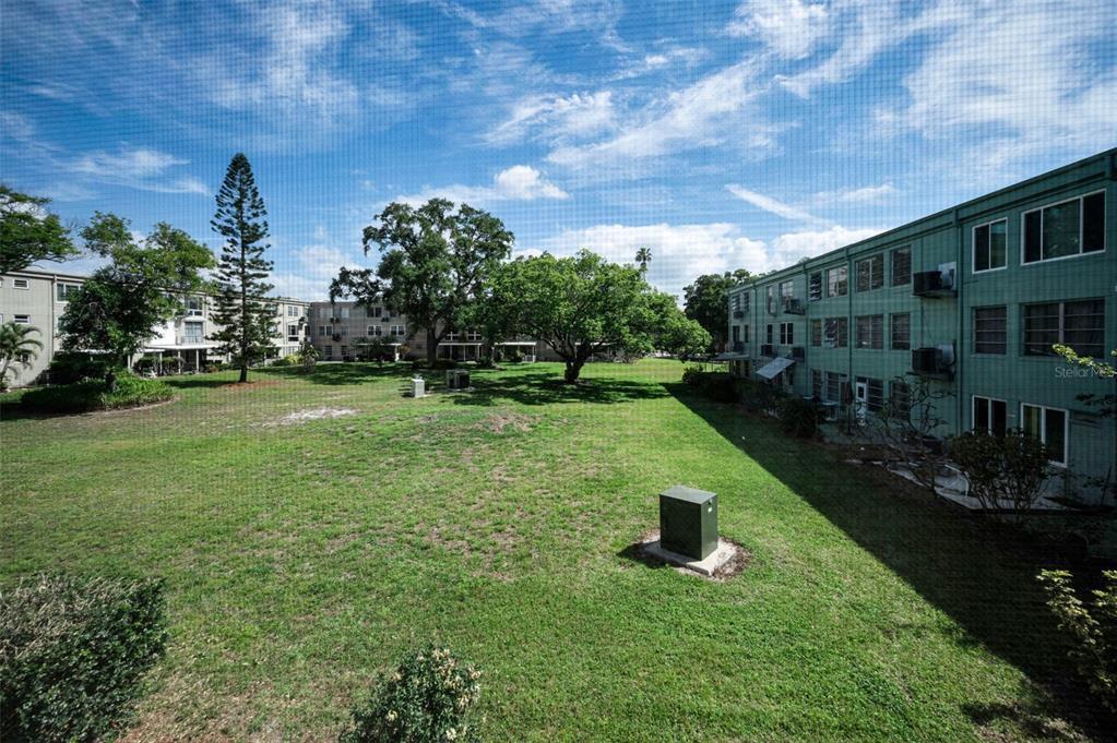 2043 Denmark Street, Unit 39 Clearwater, FL 33763 - Photo 12 of 37 a view of a garden with a bench