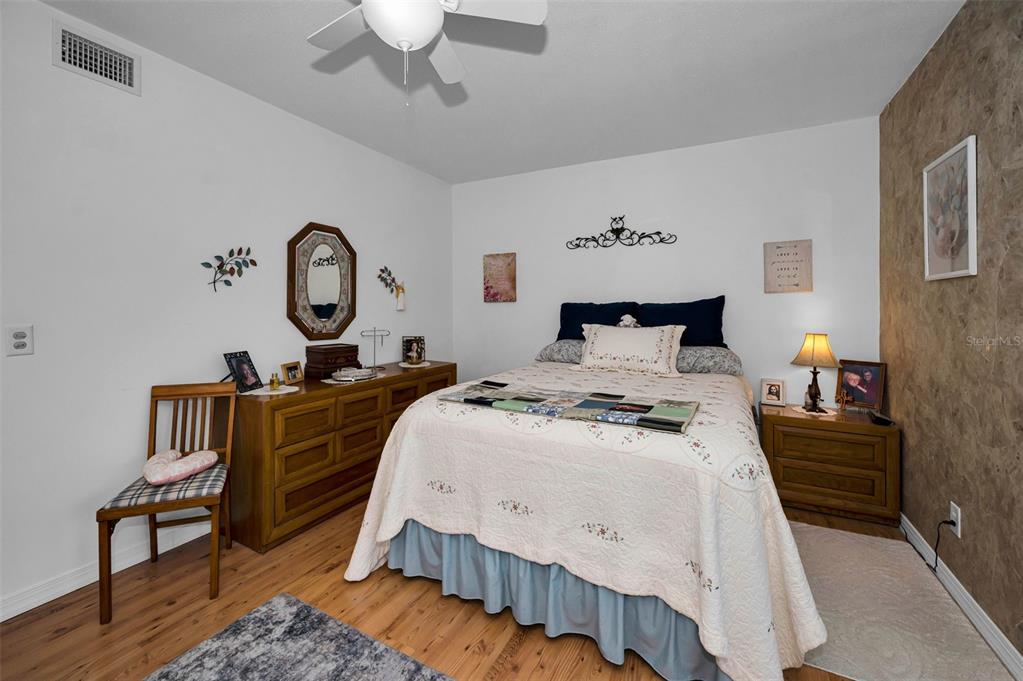 2043 Denmark Street, Unit 39 Clearwater, FL 33763 - Photo 15 of 37 a bedroom with bed and a chandelier