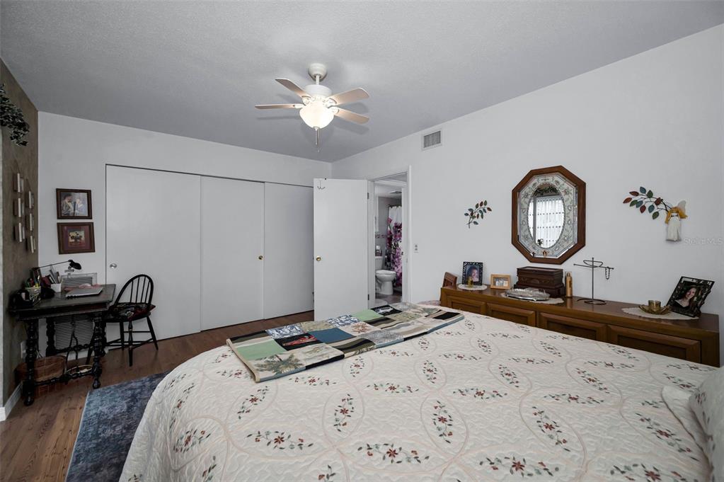 2043 Denmark Street, Unit 39 Clearwater, FL 33763 - Photo 16 of 37 a bedroom with bed and a dining table