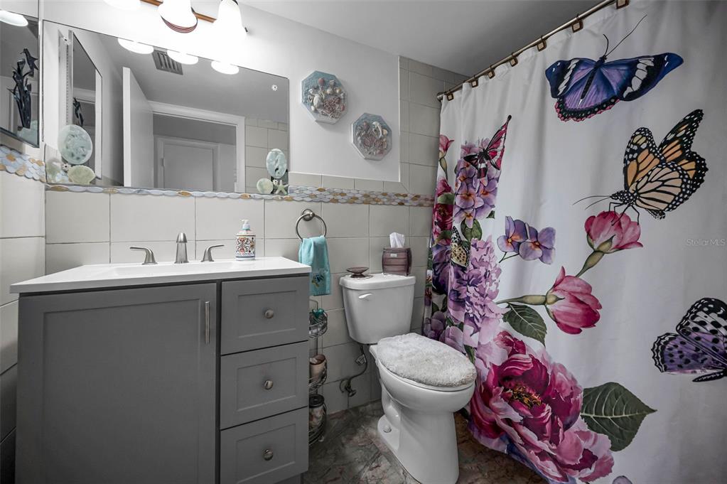 2043 Denmark Street, Unit 39 Clearwater, FL 33763 - Photo 17 of 37 a bathroom with a sink mirror vanity and toilet