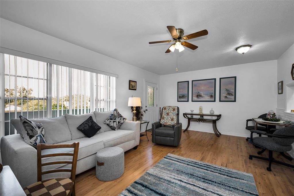 2043 Denmark Street, Unit 39 Clearwater, FL 33763 - Photo 5 of 37 a living room with furniture a ceiling fan and a large window
