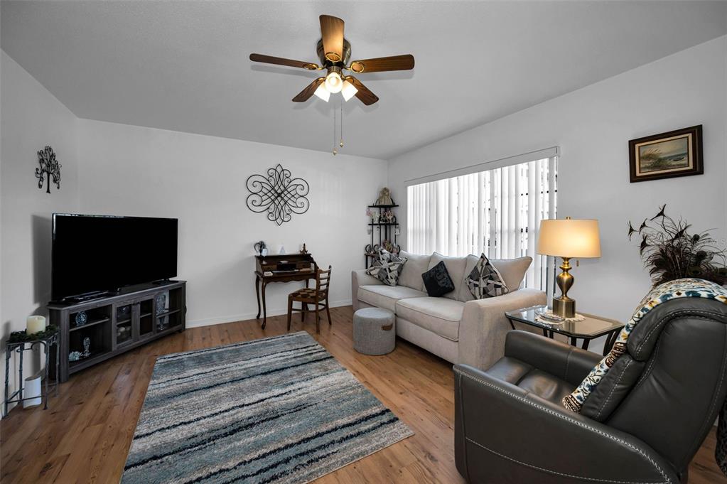 2043 Denmark Street, Unit 39 Clearwater, FL 33763 - Photo 6 of 37 a living room with furniture and a flat screen tv