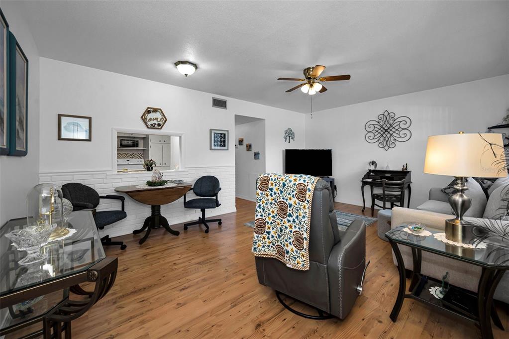 2043 Denmark Street, Unit 39 Clearwater, FL 33763 - Photo 7 of 37 a living room with furniture and a wooden floor