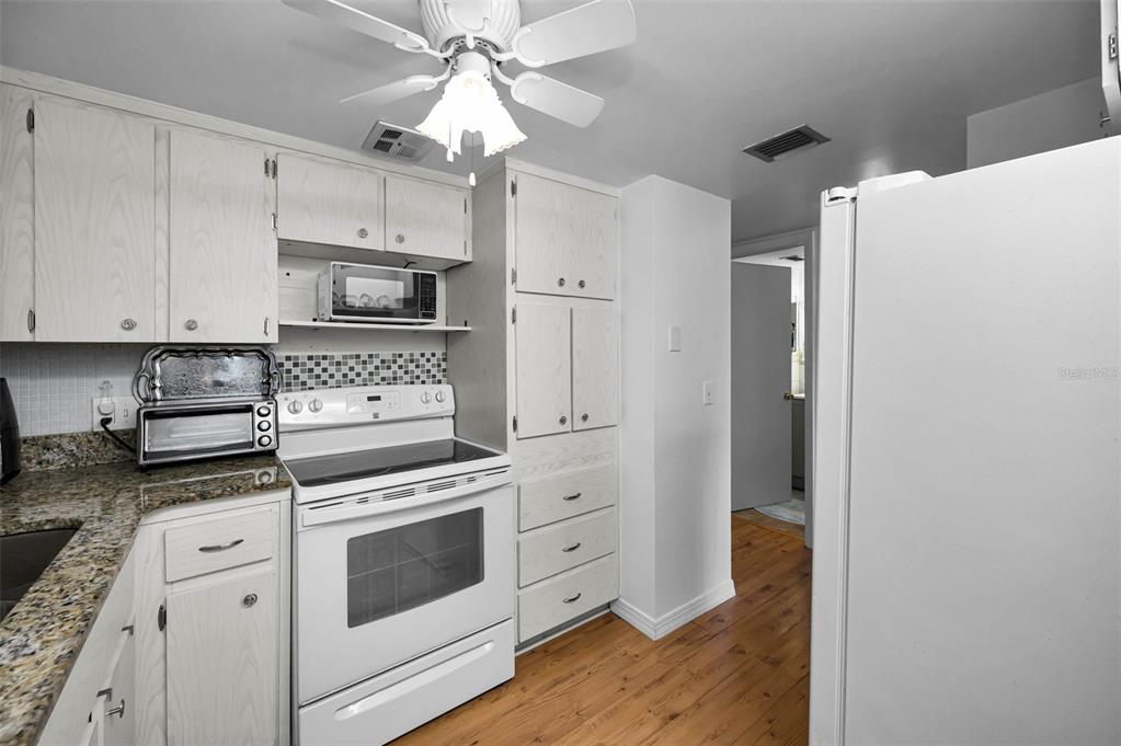 2043 Denmark Street, Unit 39 Clearwater, FL 33763 - Photo 10 of 37 a kitchen with cabinets stainless steel appliances and a counter space