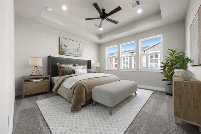 a bedroom with a large bed and a chandelier