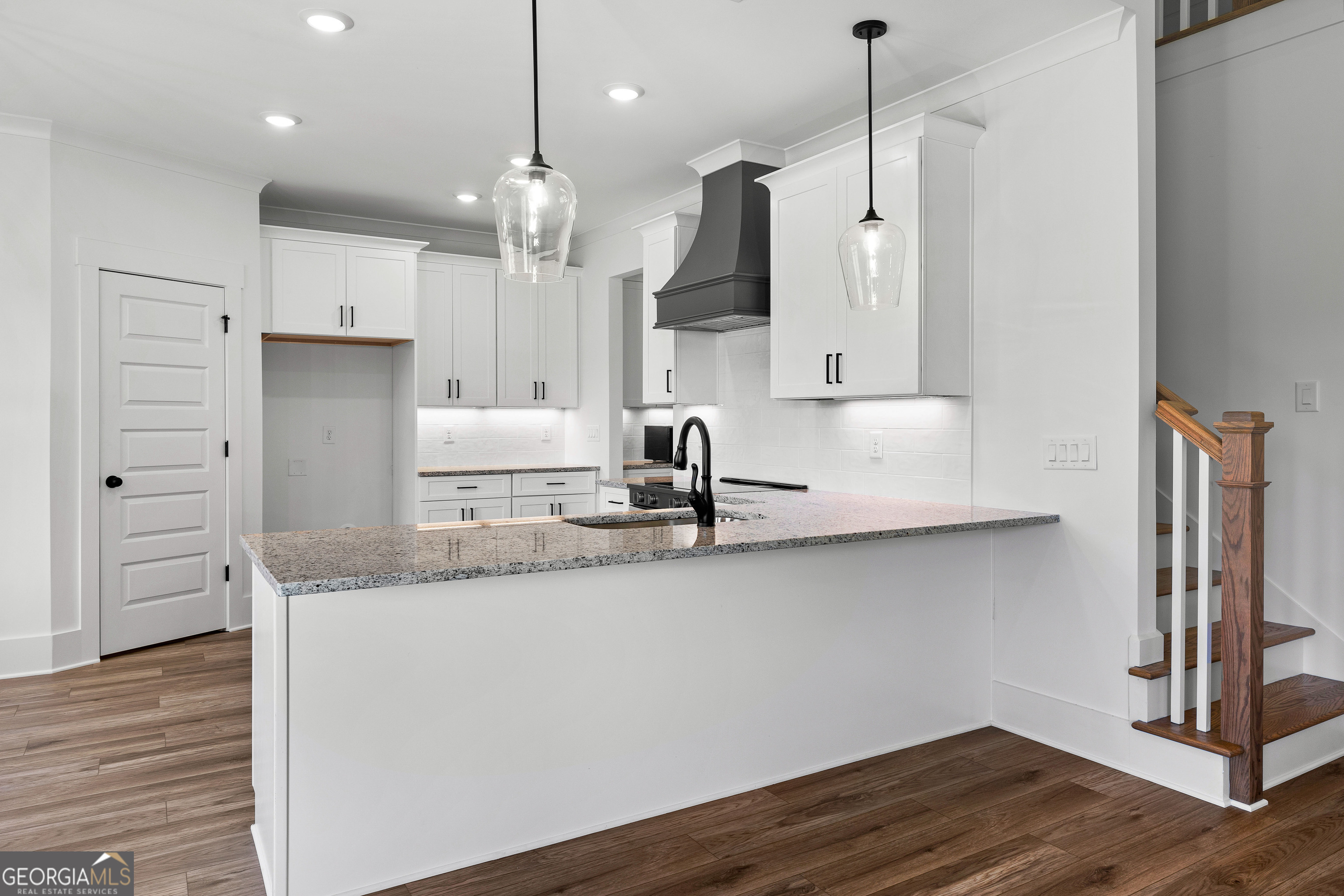374 Conner Lane Williamson, GA 30292 - Photo 16 of 52 a kitchen with kitchen island granite countertop a sink a counter space appliances and cabinets