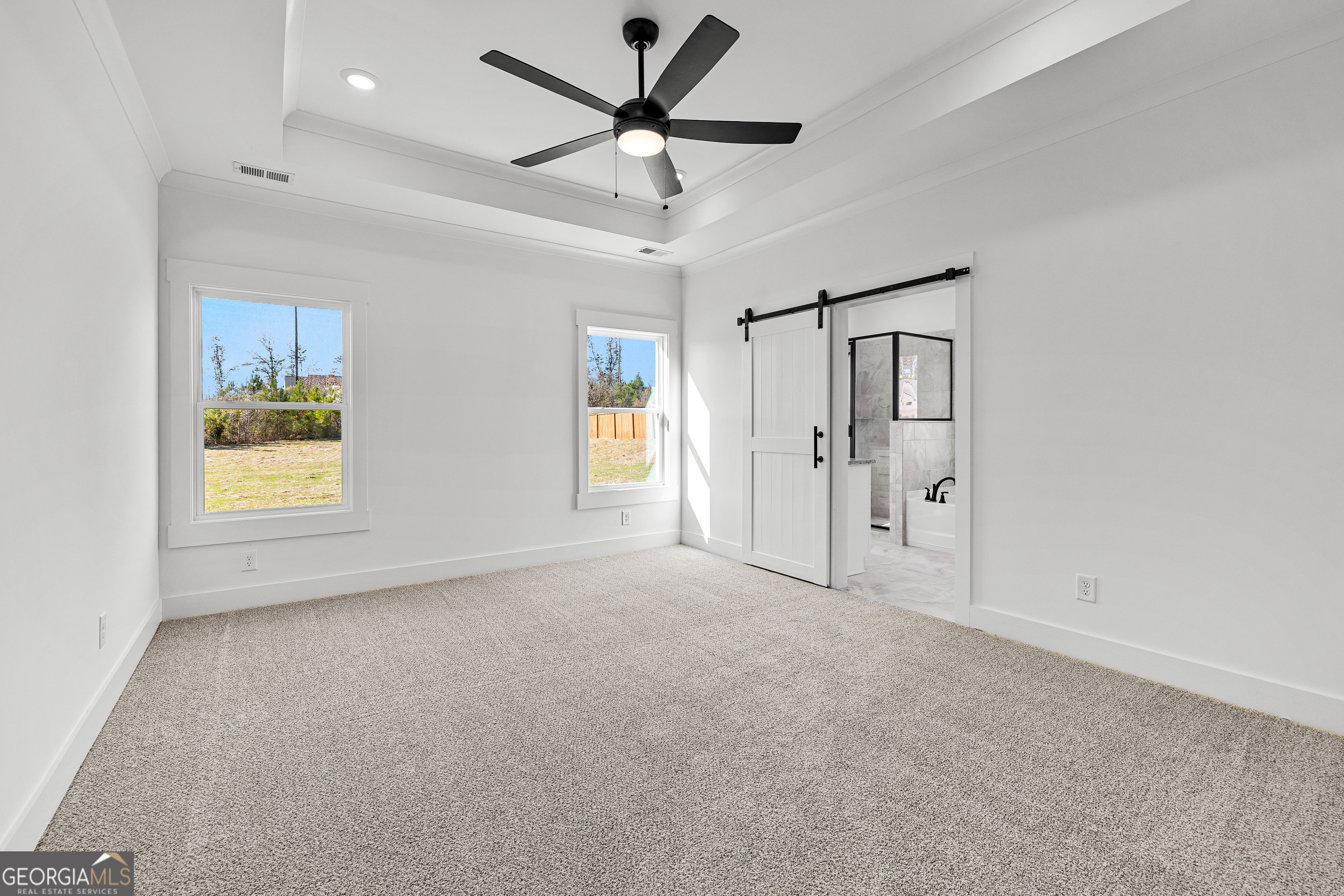 374 Conner Lane Williamson, GA 30292 - Photo 17 of 52 an empty room with windows and fan