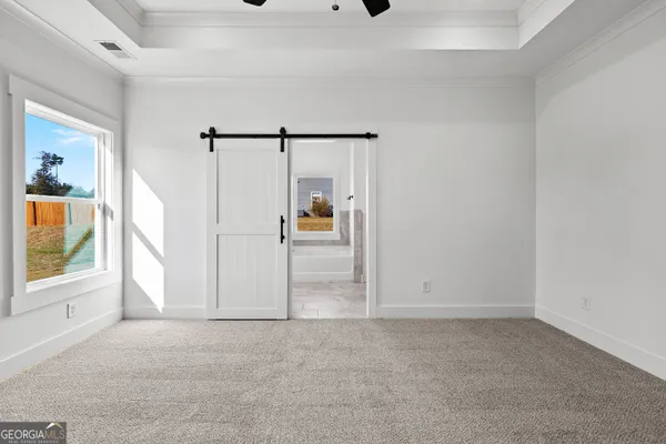 an empty room with windows and closet