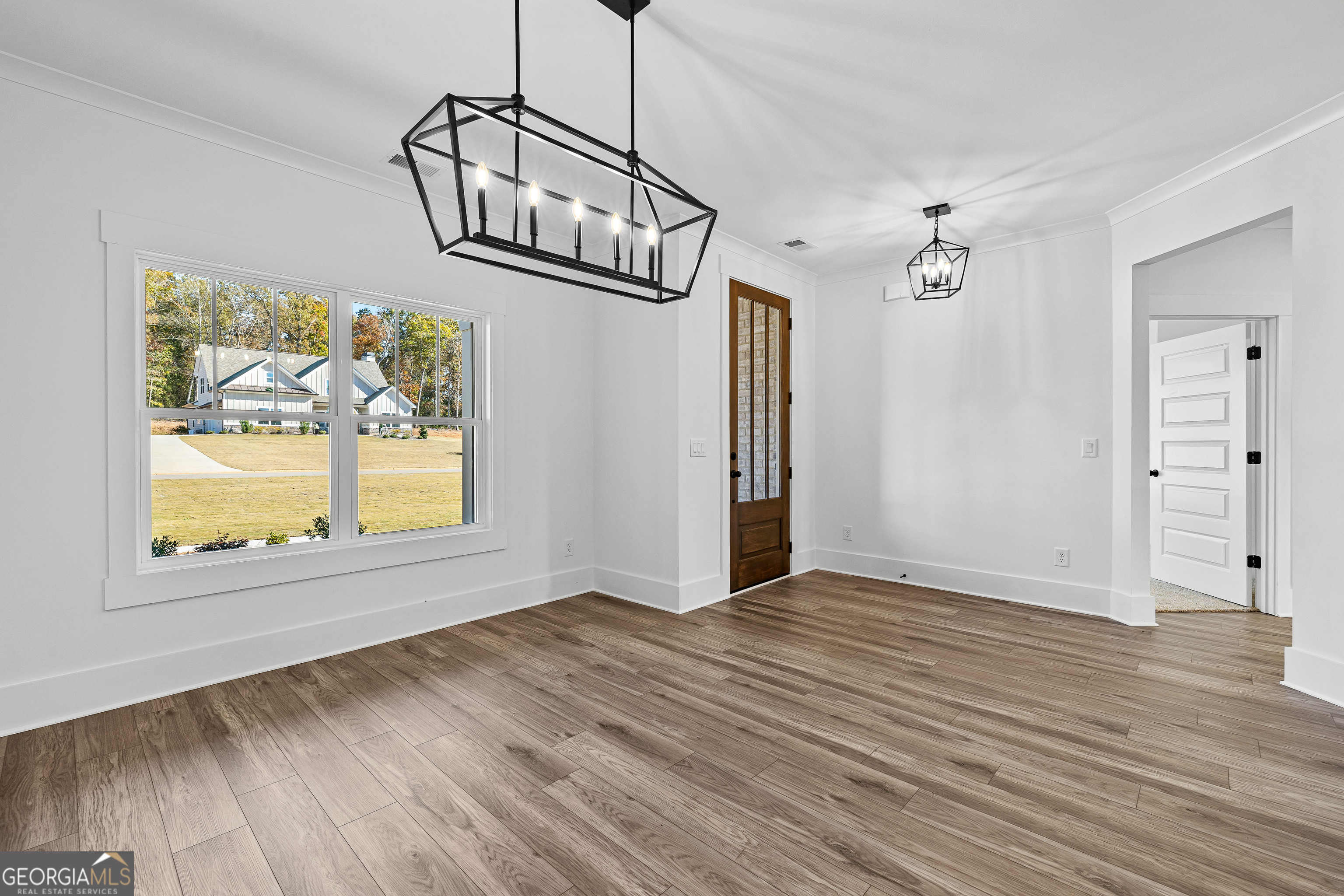 374 Conner Lane Williamson, GA 30292 - Photo 3 of 52 an empty room with wooden floor cabinet and windows