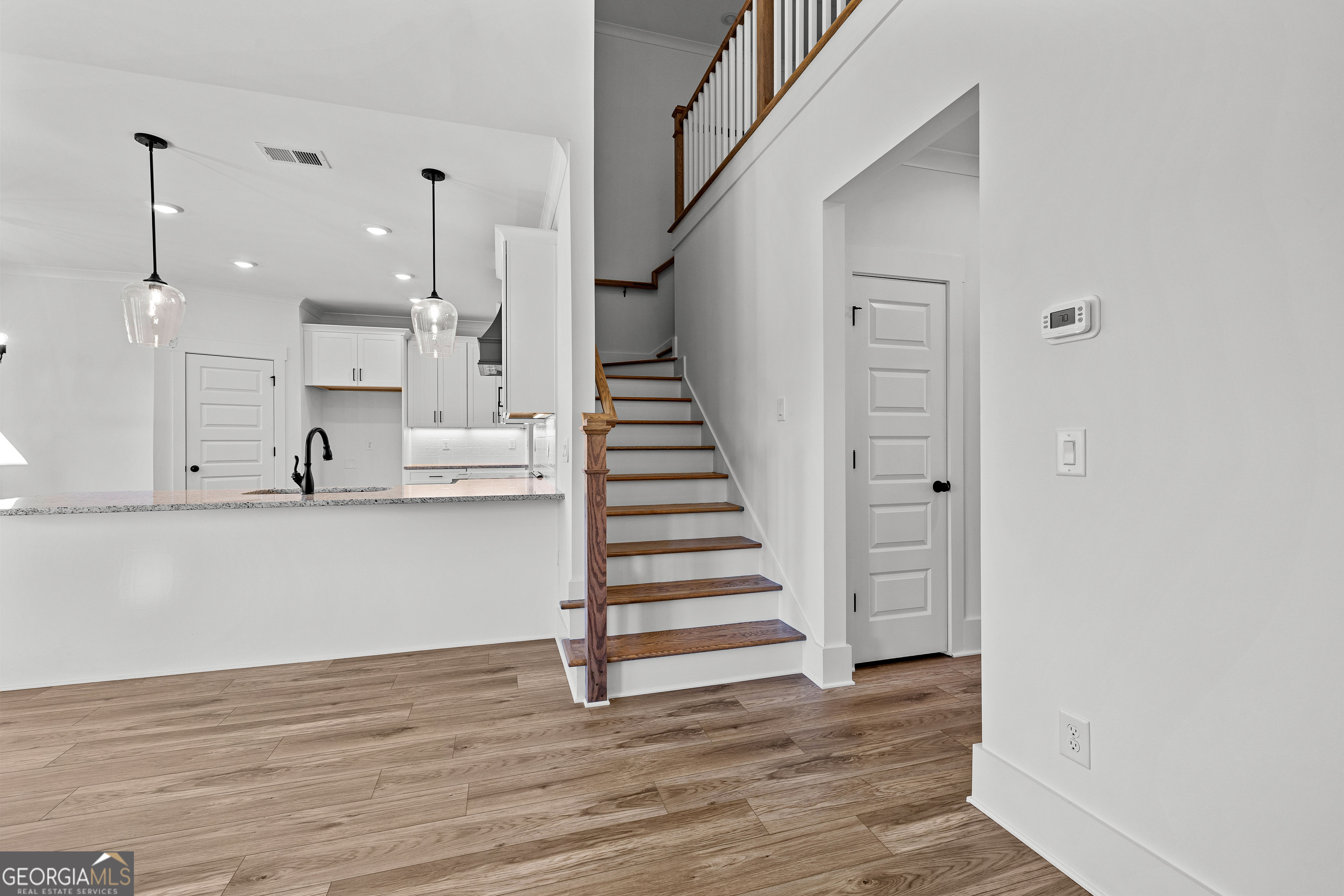 374 Conner Lane Williamson, GA 30292 - Photo 32 of 52 a view of a kitchen with wooden floor and stairs