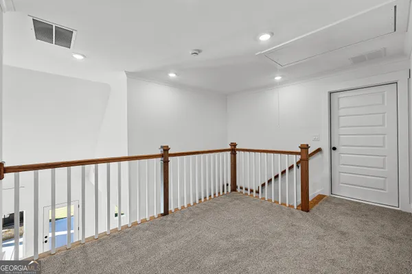 a view of a hallway with staircase