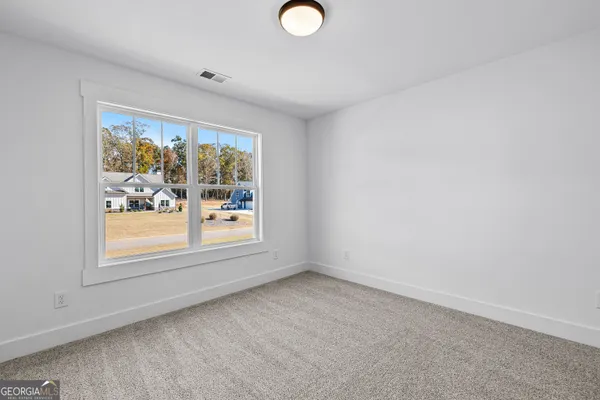 a bathroom with a granite countertop sink a toilet a mirror and shower