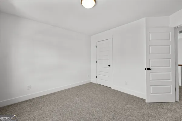 a bathroom with a granite countertop sink a toilet and a tub