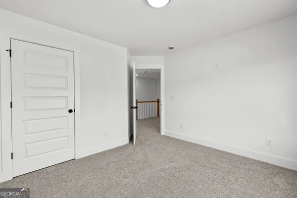 a view of empty room with wooden floor and fireplace