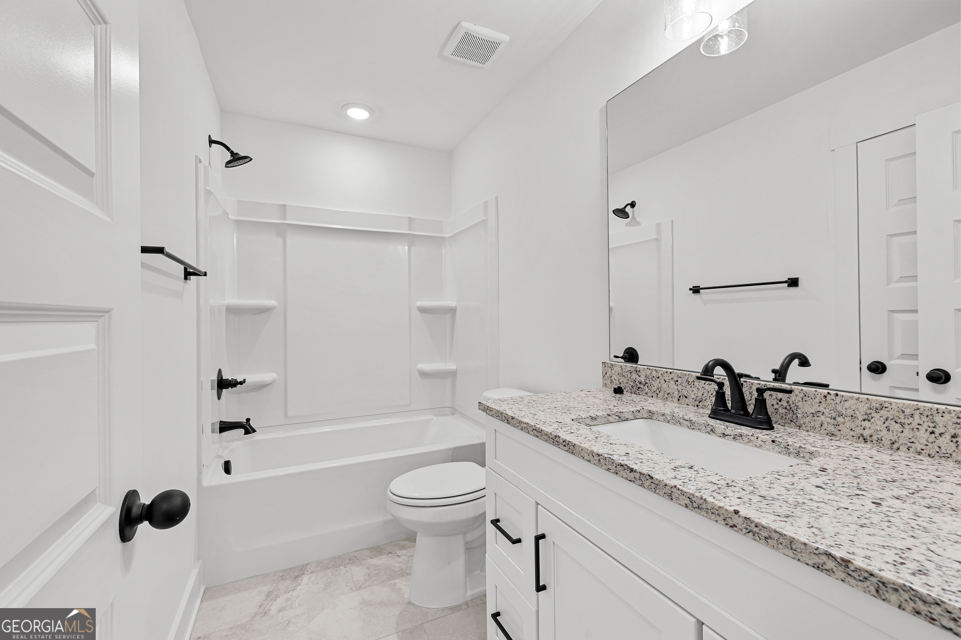 374 Conner Lane Williamson, GA 30292 - Photo 41 of 52 a bathroom with a granite countertop sink a toilet a mirror and shower