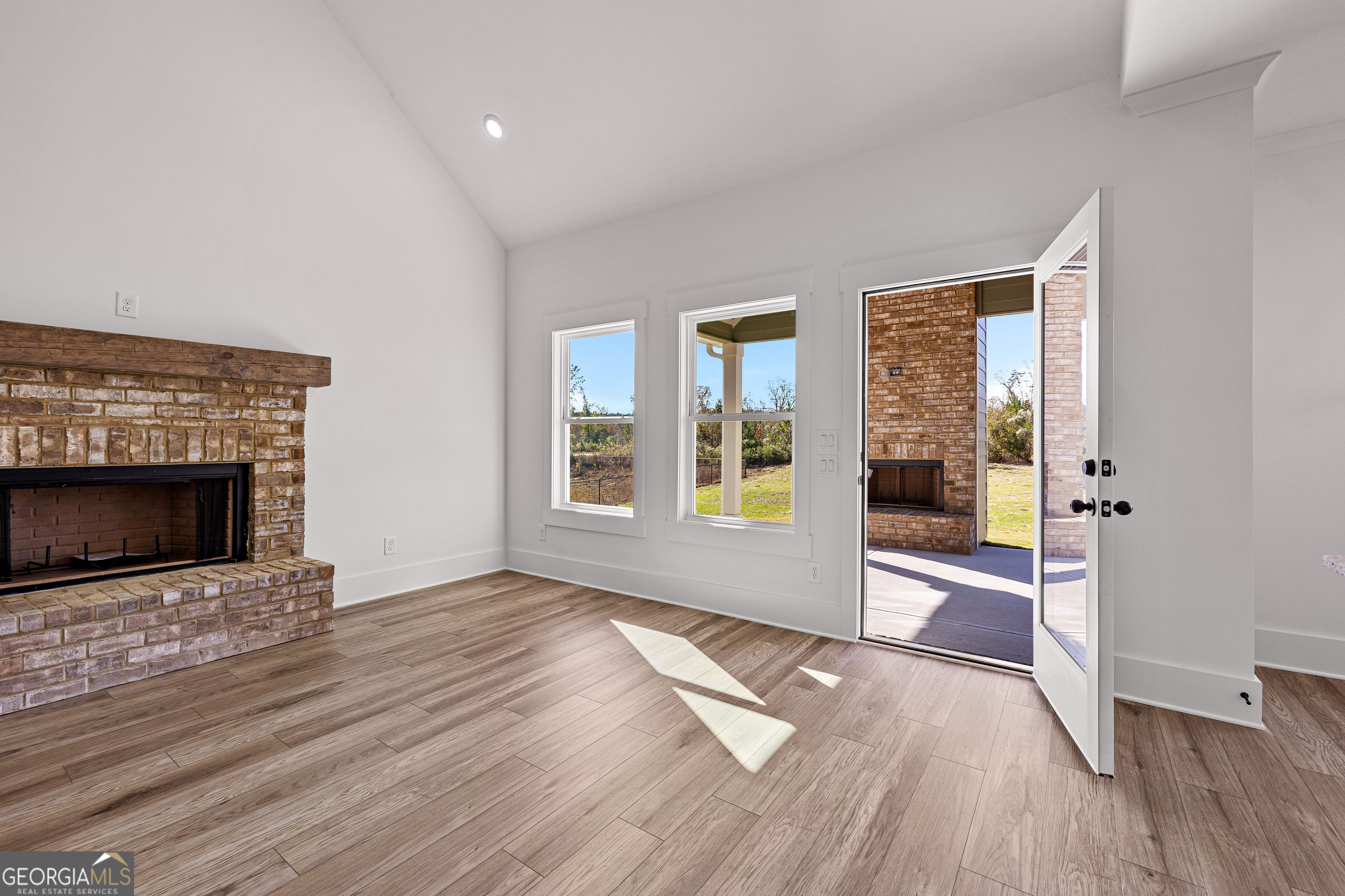 374 Conner Lane Williamson, GA 30292 - Photo 43 of 52 a view of empty room with wooden floor and fireplace
