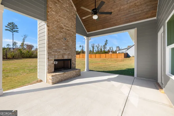 a front view of a house with a garden and tree