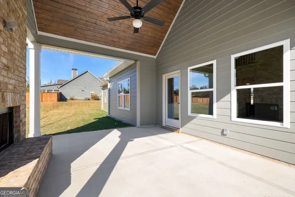 a view of a house with backyard and sitting area