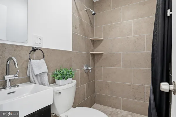 a bathroom with a sink toilet and shower