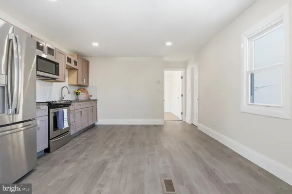 a kitchen with stainless steel appliances a refrigerator and a stove top oven
