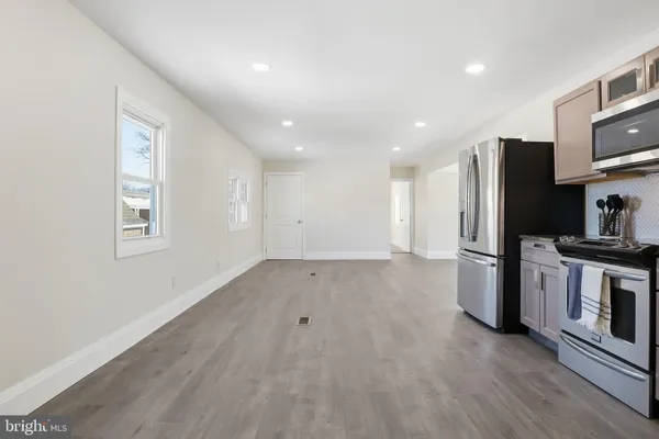 a view of kitchen with stainless steel appliances a refrigerator and a stove top oven