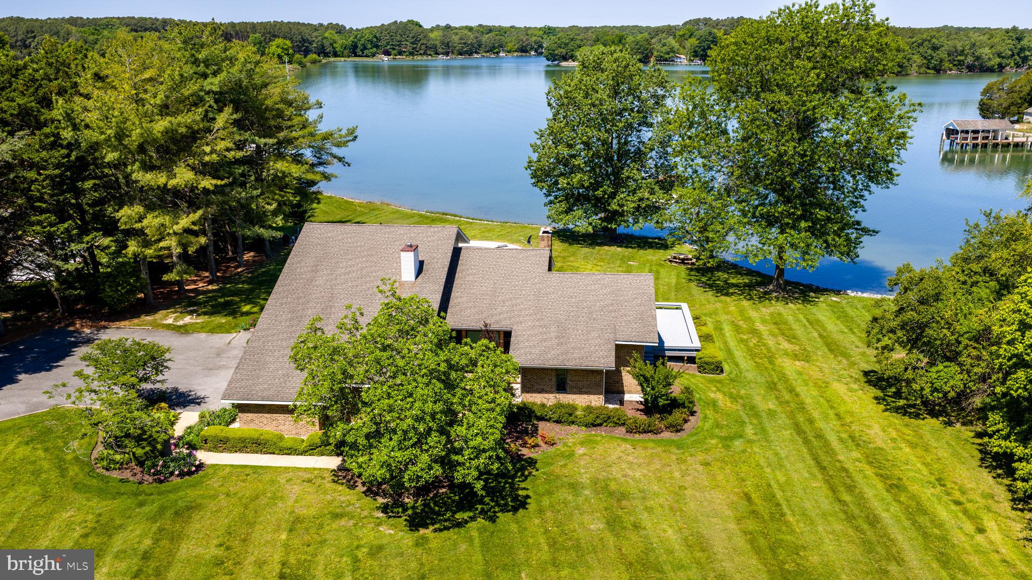 26282 Deep Water Harbor Road Easton, MD 21601 - Photo 34 of 53 an aerial view of a house with swimming pool and lake view