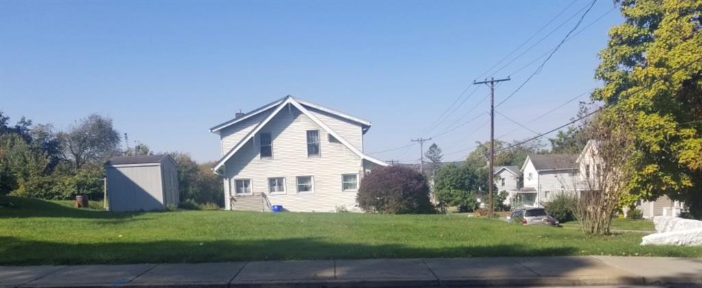 740 Chestnut Street New Castle, PA 16101 - Photo 4 of 16 a view of a white house next to a yard with big trees