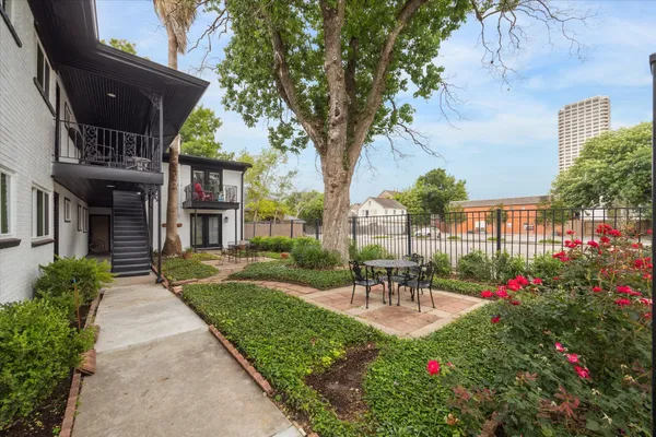 a view of a patio with table and chairs and potted plants