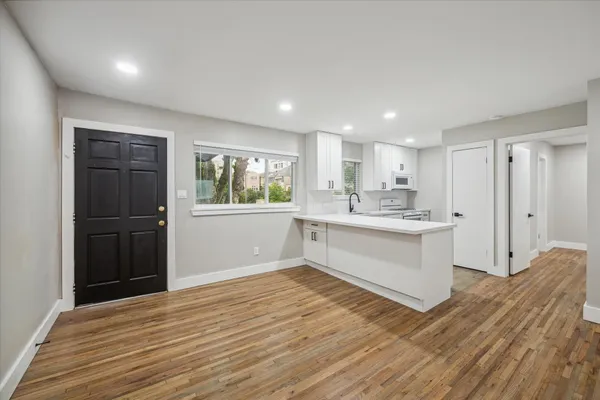 a view of kitchen with wooden floor and electronic appliances
