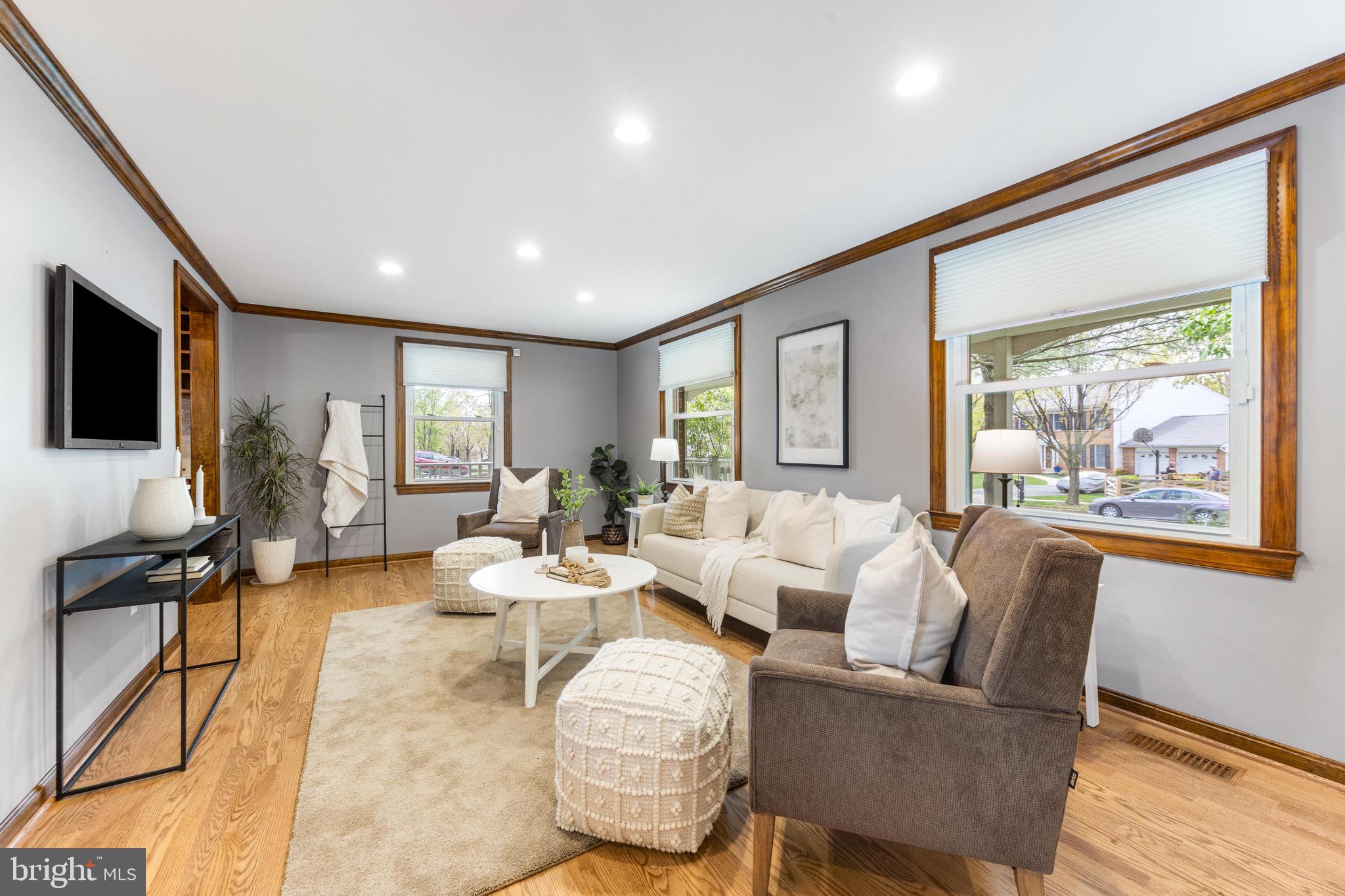 8735 Doves Fly Way Laurel, MD 20723 - Photo 11 of 64 a living room with furniture a flat screen tv and a large window