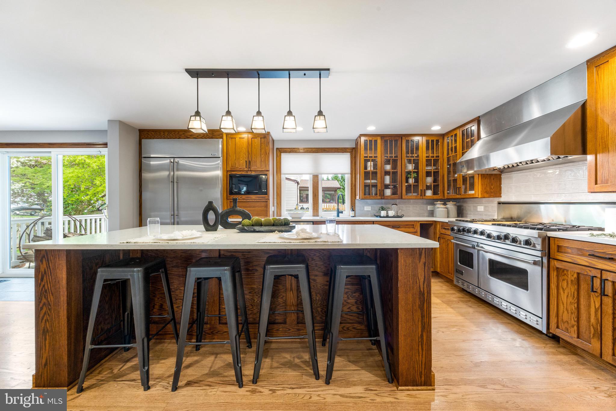 8735 Doves Fly Way Laurel, MD 20723 - Photo 17 of 64 a open kitchen with stainless steel appliances granite countertop a stove a sink dishwasher and cabinets with wooden floor