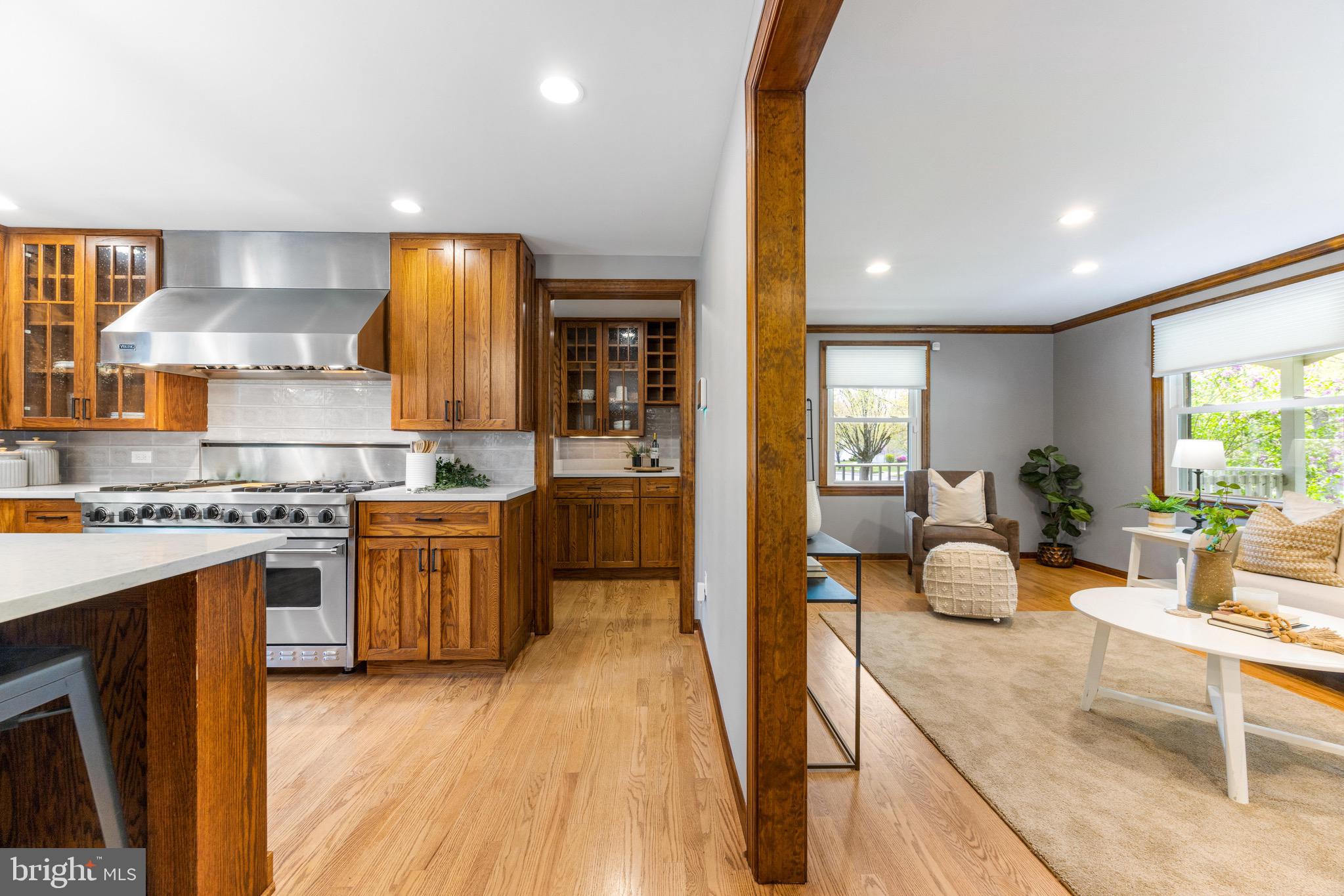8735 Doves Fly Way Laurel, MD 20723 - Photo 19 of 64 a kitchen with stainless steel appliances granite countertop wooden floors and a view of living room
