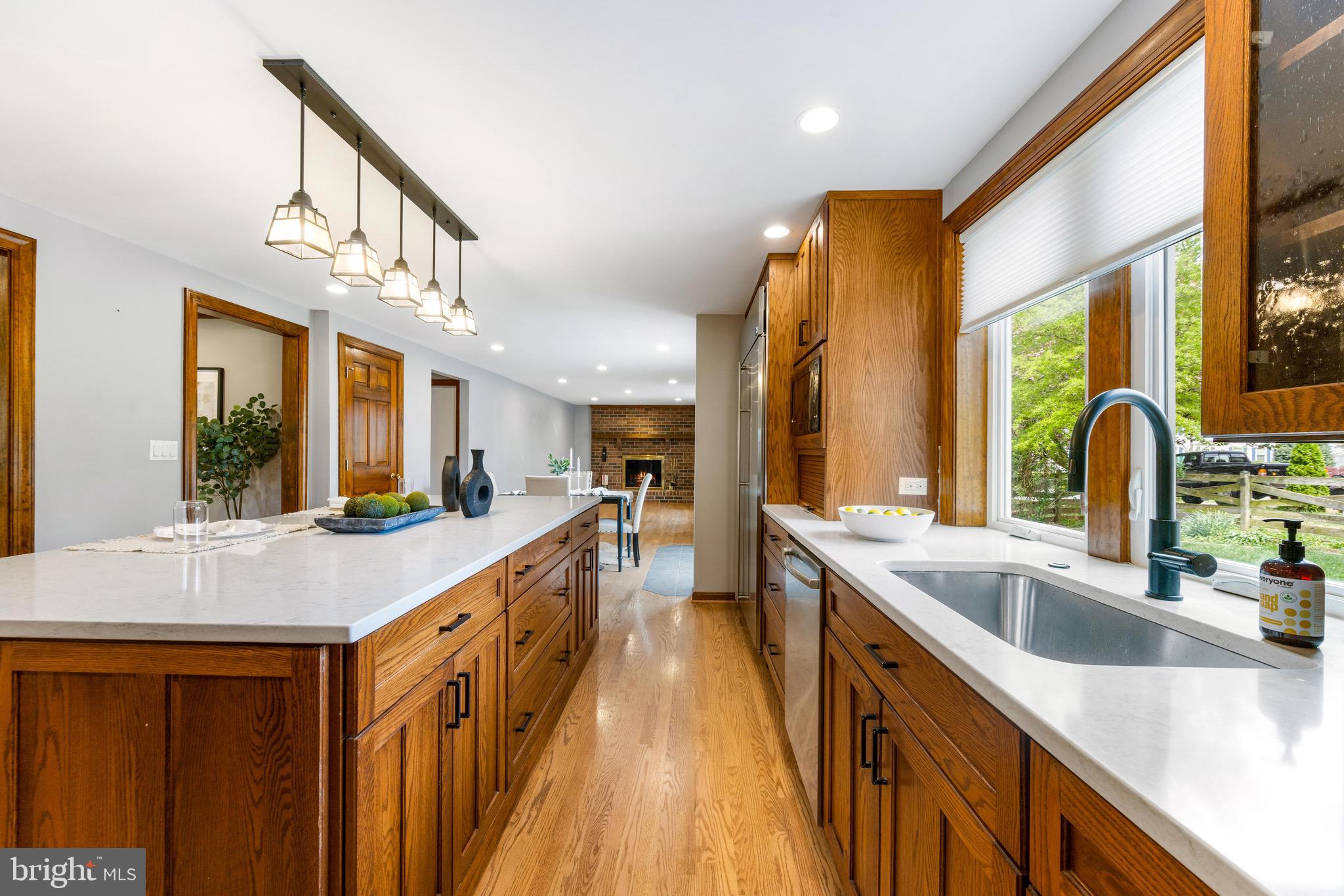 8735 Doves Fly Way Laurel, MD 20723 - Photo 21 of 64 a large kitchen with kitchen island a large window a sink and stainless steel appliances
