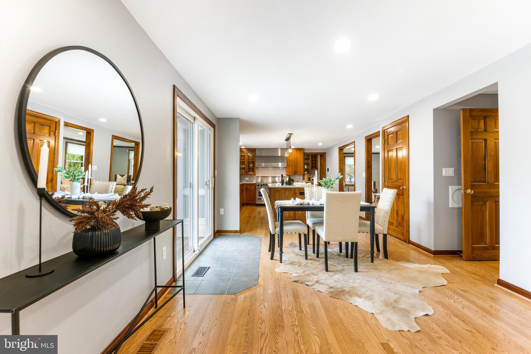 8735 Doves Fly Way Laurel, MD 20723 - Photo 32 of 64 a view of a dining room with furniture and a wooden floor