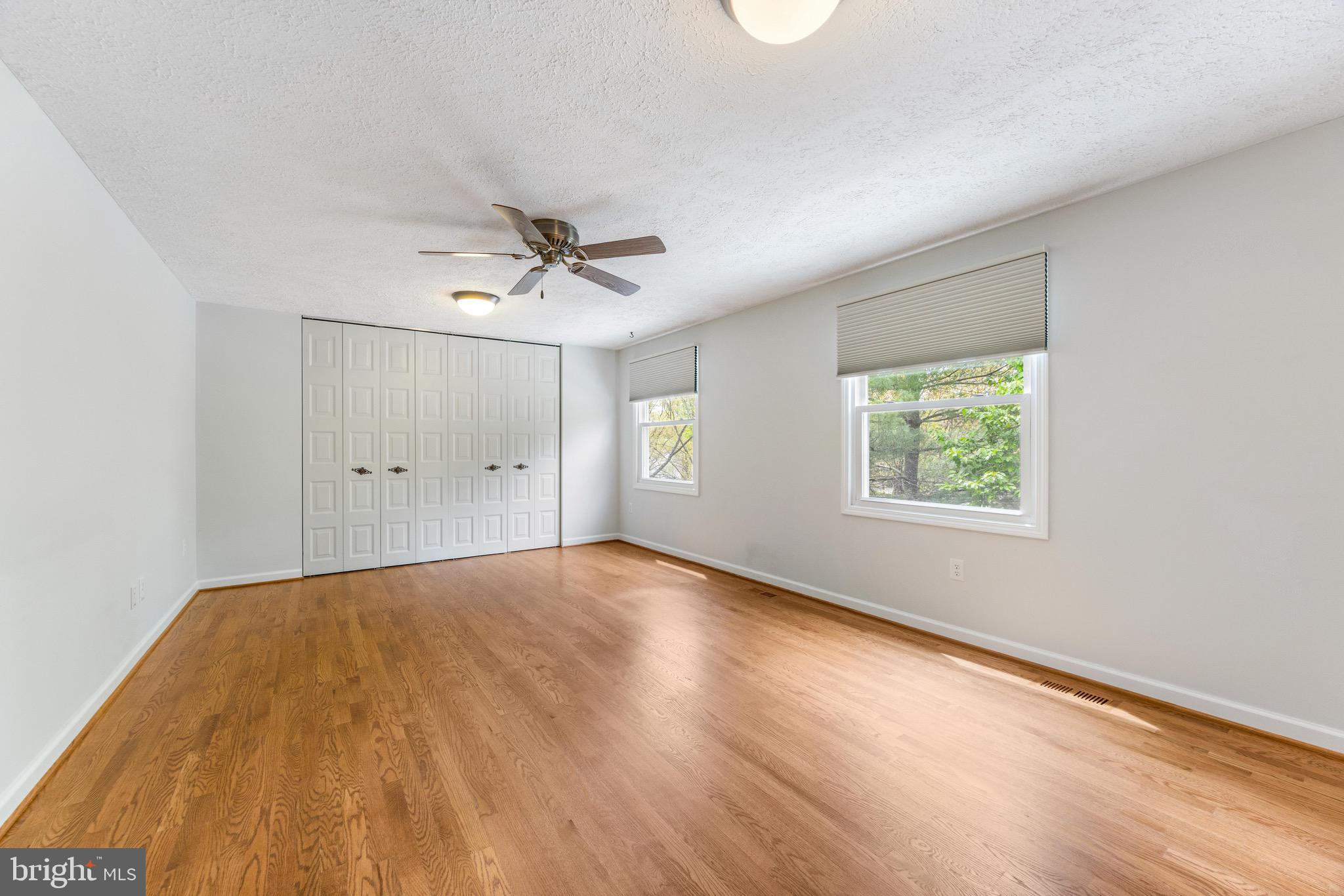 8735 Doves Fly Way Laurel, MD 20723 - Photo 34 of 64 an empty room with a window and a ceiling fan