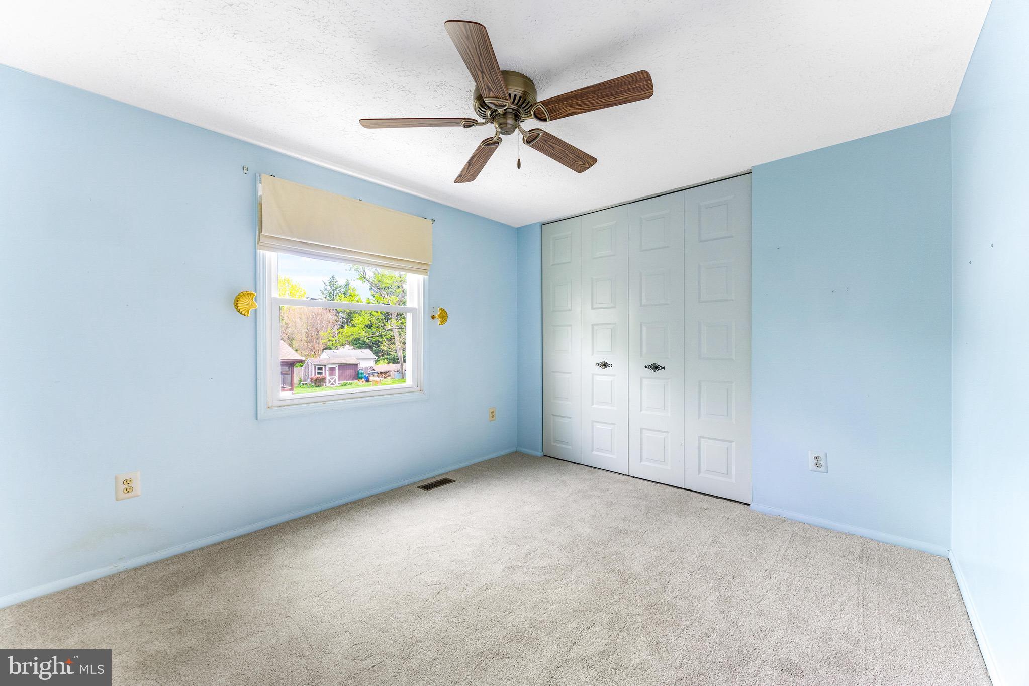 8735 Doves Fly Way Laurel, MD 20723 - Photo 38 of 64 an empty room with windows and ceiling fan